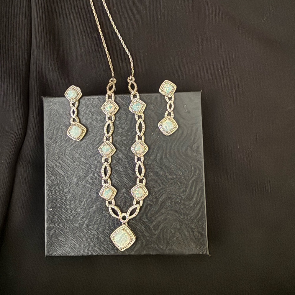 Necklace and matching pierced earrings. Lab created Opal. Diamond accent.